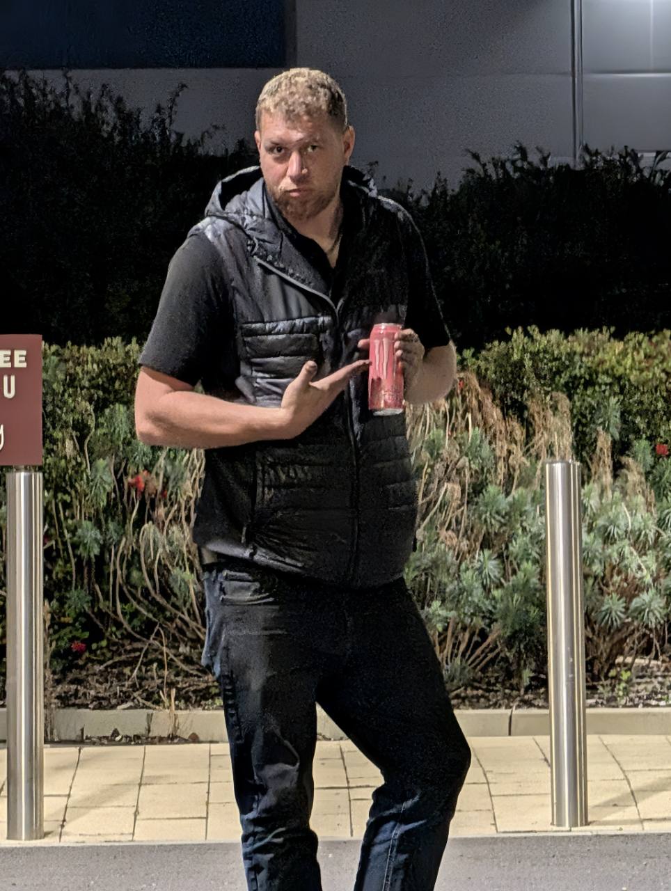 Timmeh holding a can and striking a pose